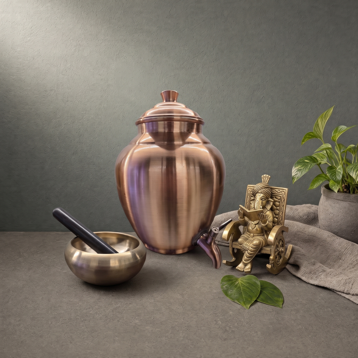 Kansa Massage Bowl with Wand, Copper Water Dispenser with Fluted Belly on a stone ledge - Peetal Parampara