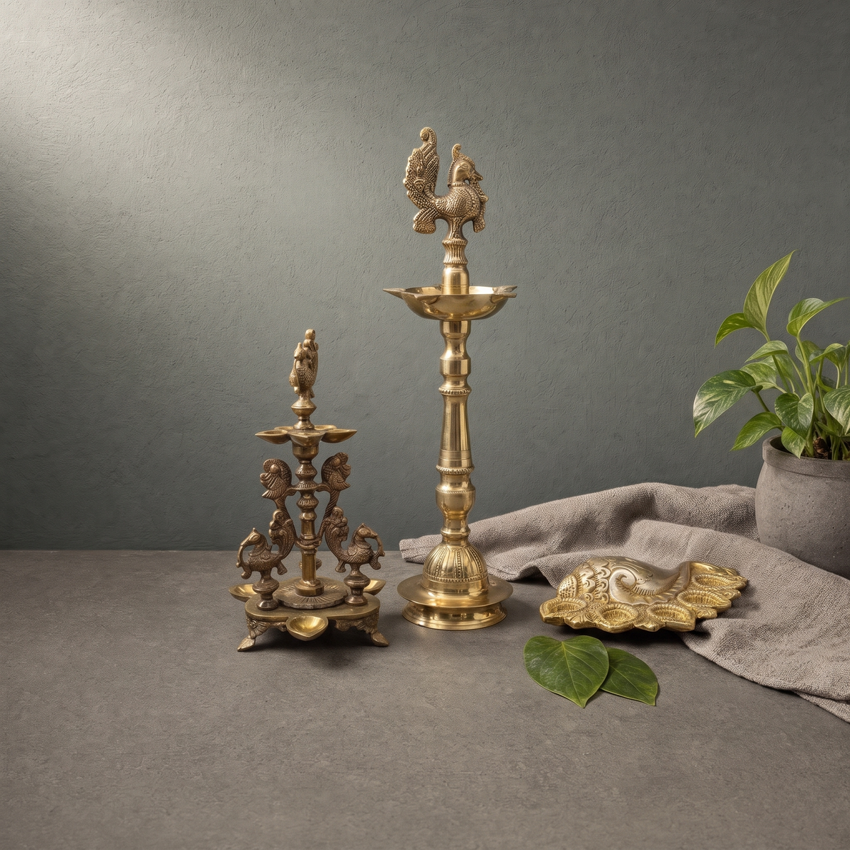 Brass Peacock Standing Diya, Antique Brass Four Peacock Diya, Brass Shankh Diya on a stone ledge - Peetal Parampara