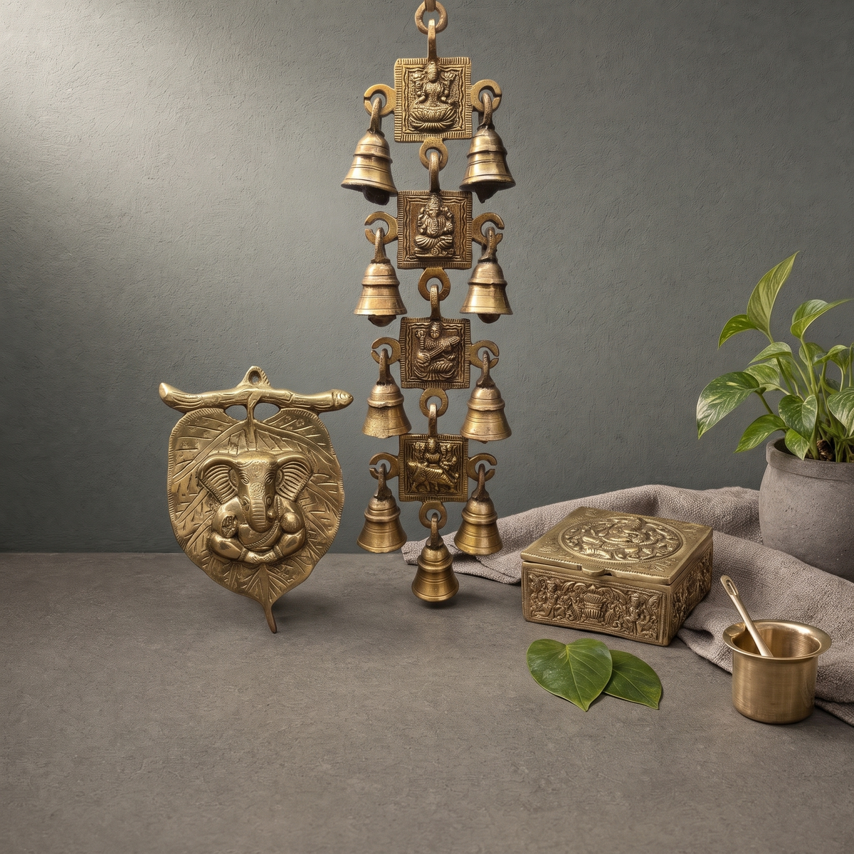 Brass Jewellery Box with Ganesh Lid, Brass Ganesha on Leaf, Antique Brass Hanging Bells on a stone ledge - Peetal Parampara