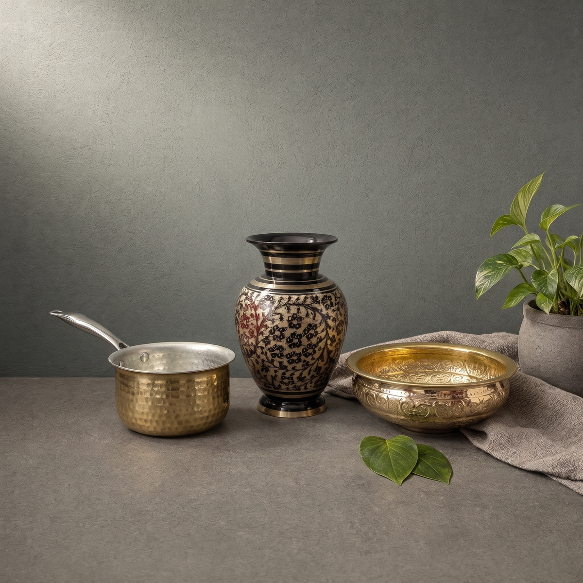 Hand Engraved Brass Vase in Black, Hand Hammered Brass Saucepan on a stone ledge - Peetal Parampara
