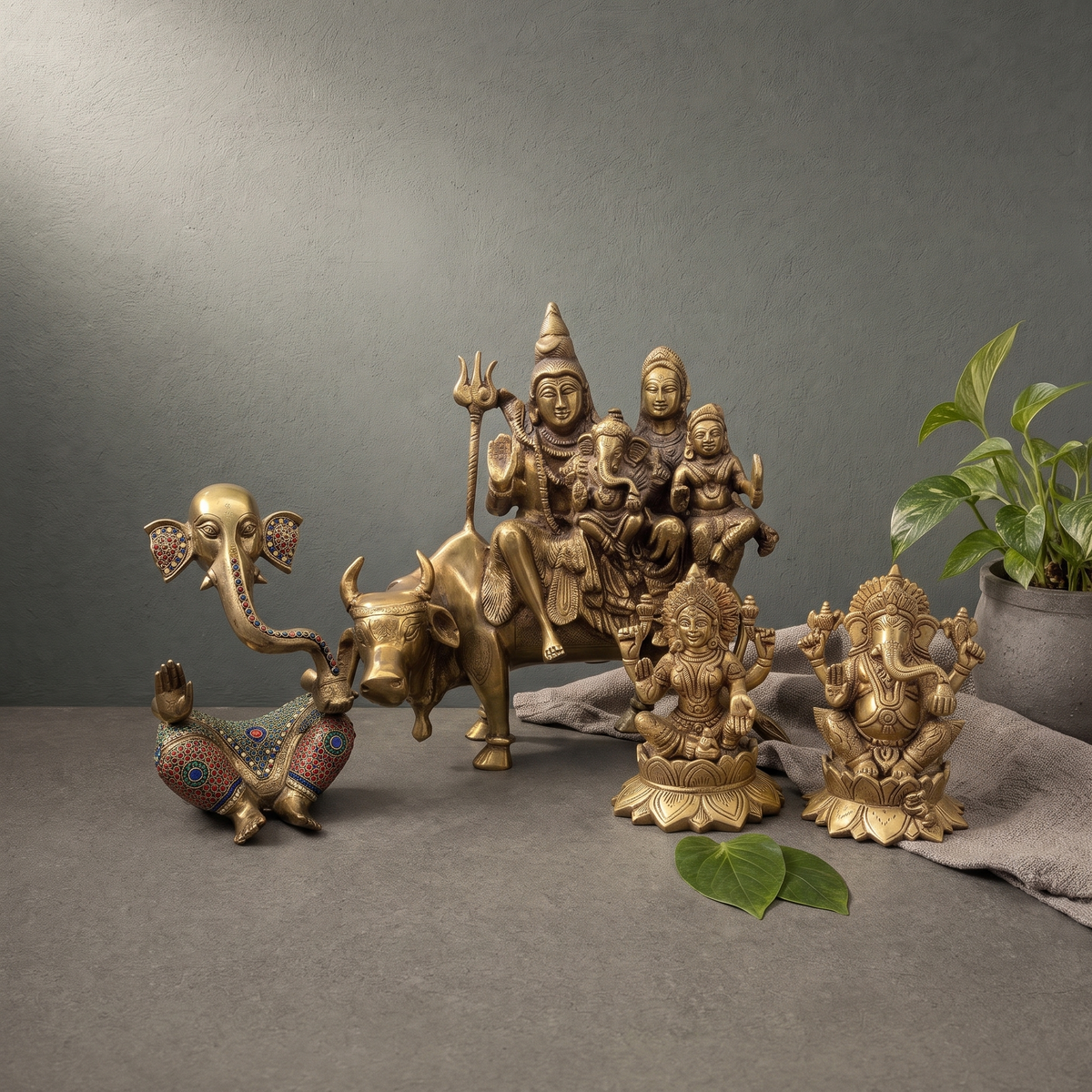 Antique Brass Ganesh Murti with Stone Inlay, Antique Brass Shiv Parivar Murti on Nandi on a stone ledge - Peetal Parampara