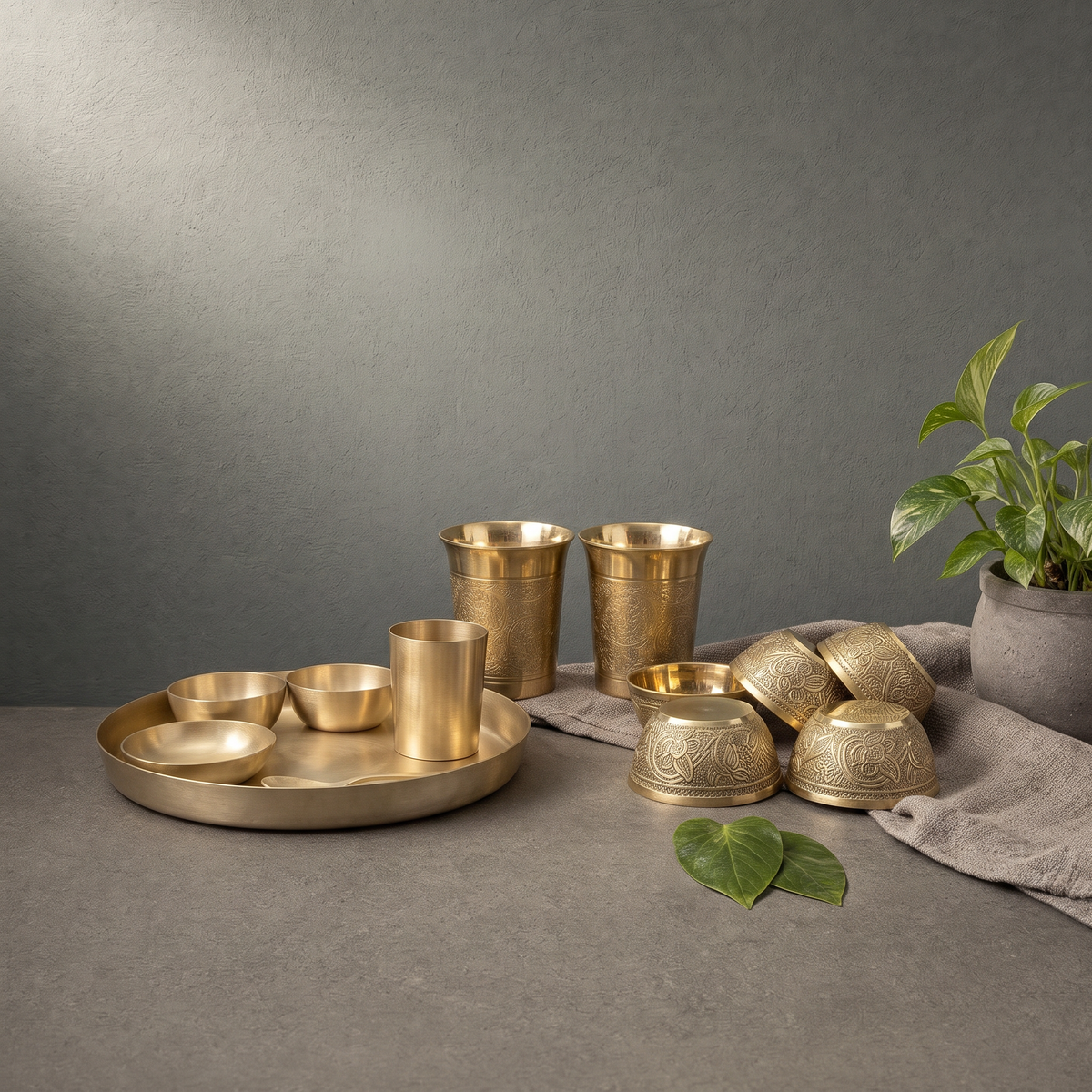 Kansa Thali Set with Katori, Brass Katori with Floral Relief on a stone ledge - Peetal Parampara