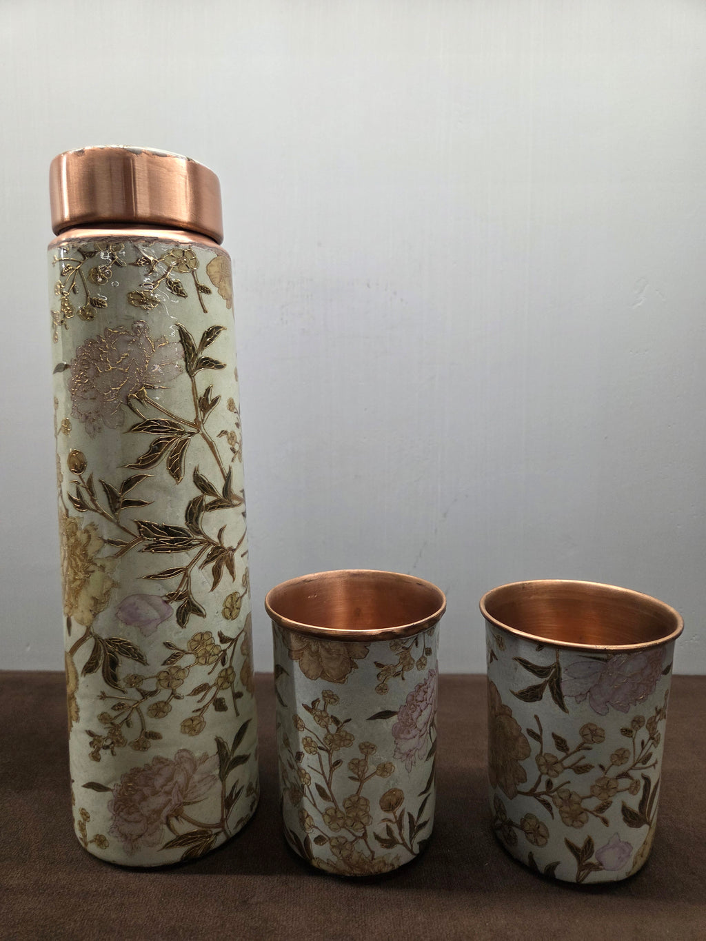 Copper bottle and two tumblers printed with peonies and blossom sprigs over a crackled cream ground - Peetal Parampara