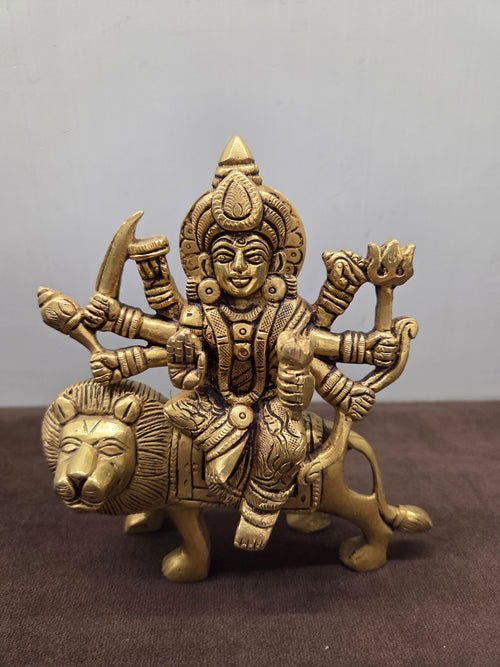 Cast brass Durga with eight arms seated side saddle on a lion that stands on four legs, no plinth - Peetal Parampara