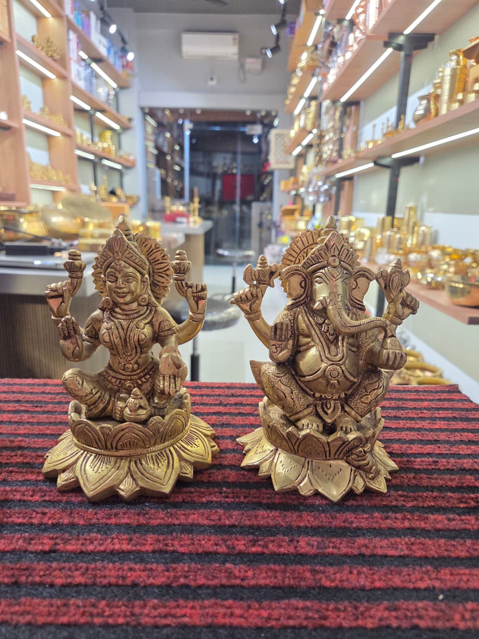 Pair of cast brass Laxmi and Ganesh figures on flared lotus bases, four arms each, mouse at a corner - Peetal Parampara