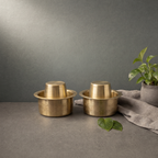 Brass Filter Coffee Tumbler Set on a stone ledge against a grey plaster wall - Peetal Parampara