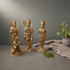 Superfine Brass Ram Darbar Murti on a stone ledge against a grey plaster wall - Peetal Parampara